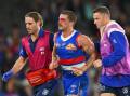 A bloodied Tom Liberatore is helped from the field late in the Bulldogs' loss to Hawthorn. (Morgan Hancock/AAP PHOTOS)