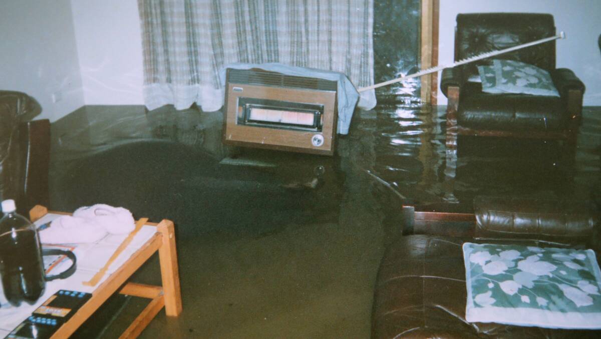 Jason Field still keeps a snap lock bag filled with images of his home after the 1998 floods - this was his loungeroom. Picture: supplied.