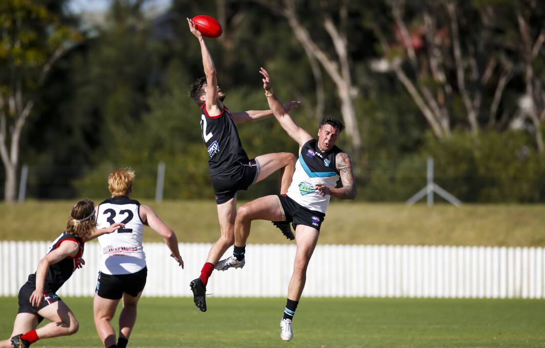 Action from the Wollongong Lions win over Kiama Power in the AFL South Coast's Men's Premier Division at North Dalton Park on Saturday. Pictures: Anna Warr