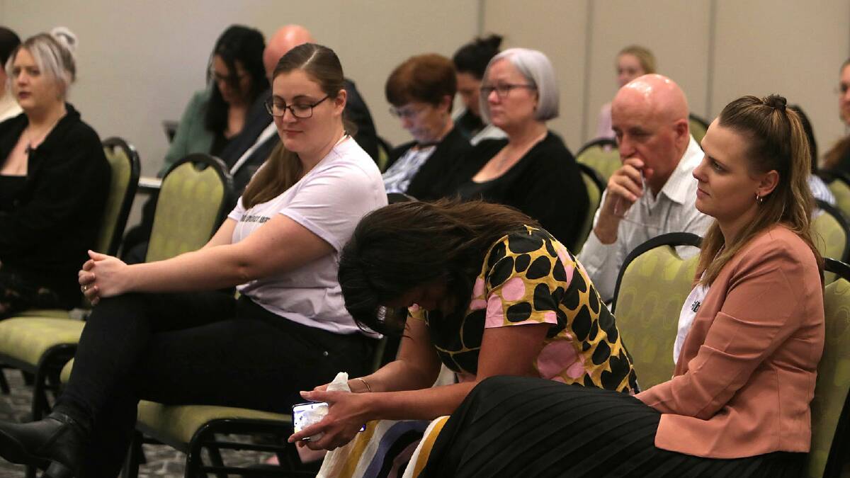 Better Births Illawarra's Sharon Settecasse (head bowed) and Alyssa Booth (right) watch women giving evidence at the public hearing. Picture by Sylvia Liber
