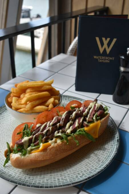 The Waterfront Tavern's footlong steak sandwich, topped with roquette and blue cheese miso sauce on a super-sized sourdough bun.