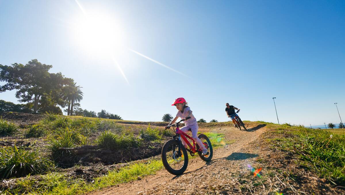 Families enjoyed the autumn sunshine in the Illawarra, including Lily and Andy Brown at the Bulli mountain bike track. Picture by Anna Warr