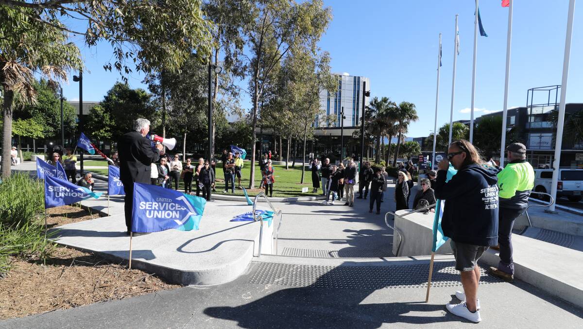 South Coast Labour Council secretary Arthur Rorris addresses workers and supporters who rallied outside Shellharbour council. Picture by Robert Peet