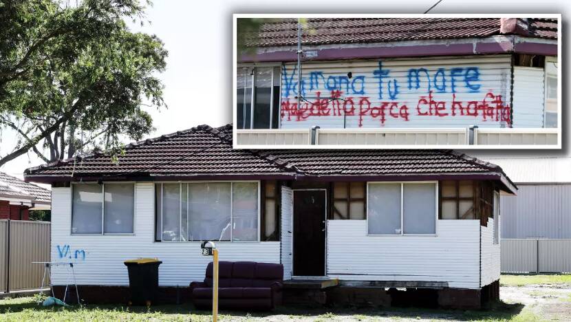 Some of the cladding has been ripped off Soster's house, exposing the structural beams and, inset, vile language painted on the side of property in Italian. Pictures by Sylvia Liber
