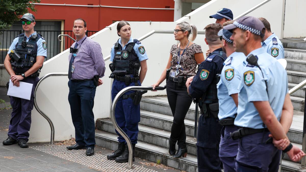 Police officers guarding the entry to Wollongong courthouse after a group of 30 were escorted outside. Picture by ACM