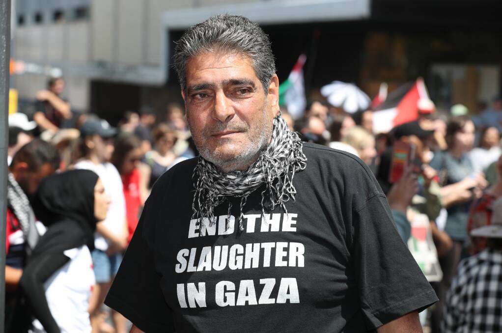 Saeb Ali wearing a t-shirt he made in 2016, during "one of the massacres" committed against Palestinian civilians in Gaza. Picture by Robert Peet
