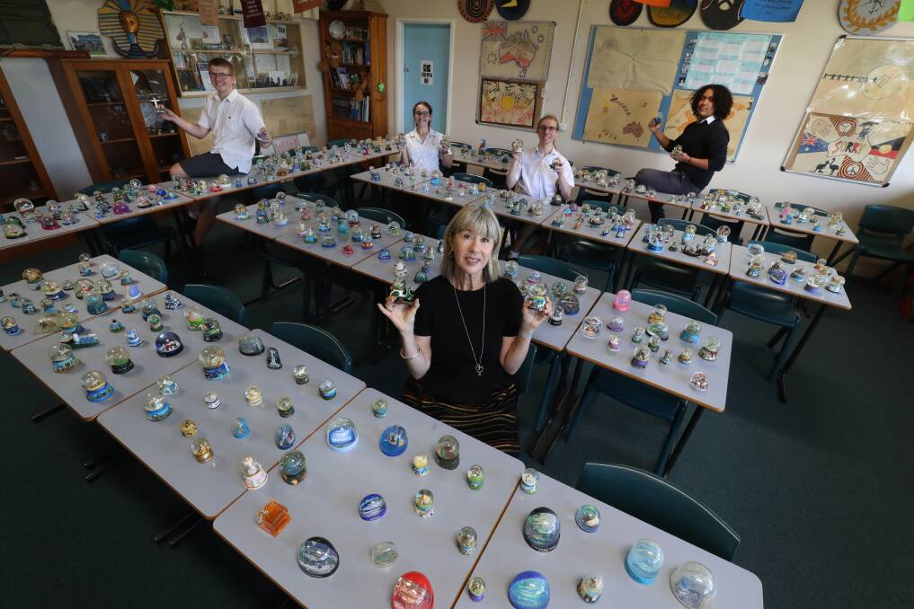 Retiring Smith's Hill High School teacher Kerry-Lee Doyle with students Connor MacKay, Issy Brightman, Callum Belgrove and Jordan Lee with some of her record-breaking collection of snow globes. Picture by Robert Peet.
