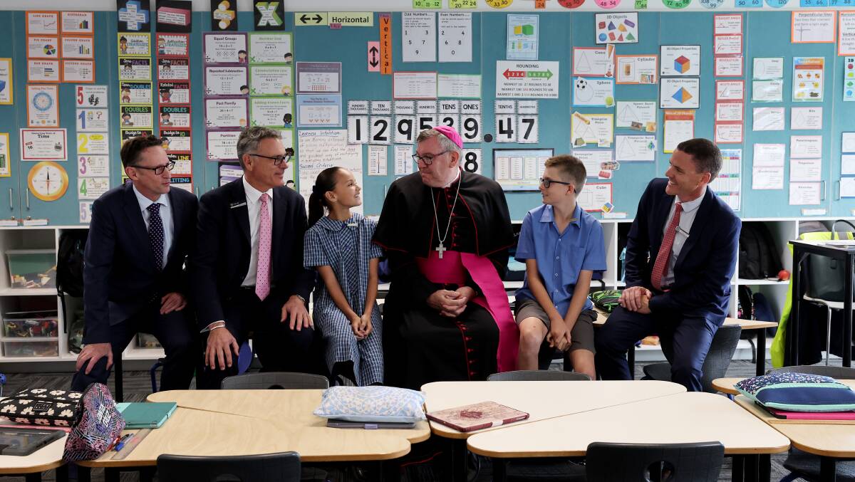 Member for Whitlam Stephen Jones, Director of Schools of CEDoW Peter Hill, school captain Ella Primmer, Bishop of Wollongong Brian Mascord and school captain Grady Farrugia, and Acting Principal Matthew Downes in a classroom at St John's Catholic Parish Primary School. Picture by Sylvia Liber