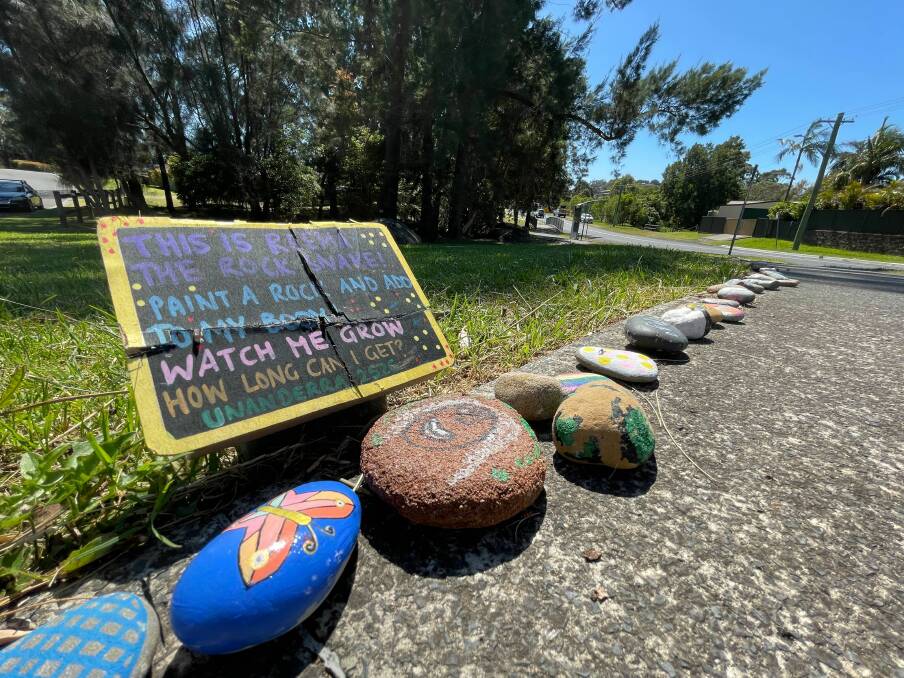 The line of hand painted rocks sits on the intersection of Alukea Rd and Central Rd in Cordeaux Heights.