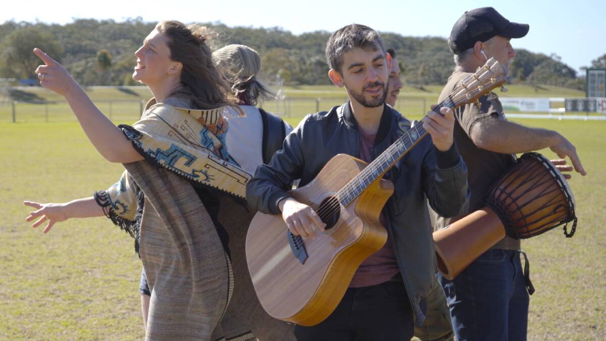 Sakana Nation band at Rex Jackson Oval in Helensburgh. From left, Izzy Russell the vocals, Allen Rodrigues plays guitar, Simon Fuhrer plays drums. Still photo of the music video of 'Watching Matildas'. Picture supplied
