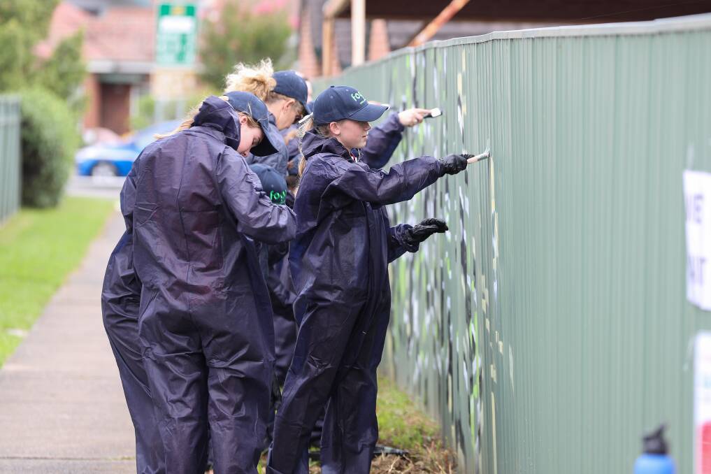 Students from Albion Park High removing graffiti in Albion Park. Picture by Adam McLean