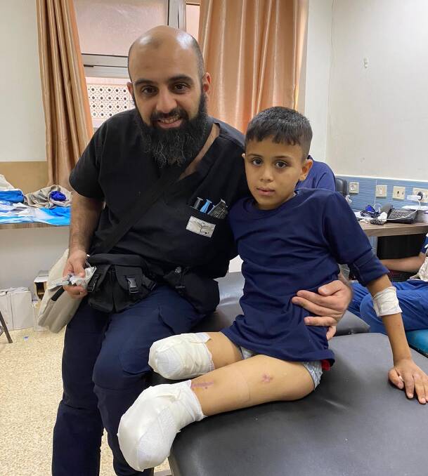 Dr Modher Albeiruti with a young patient in Gaza. Picture supplied 
