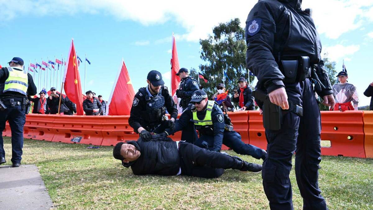 A protester for Tibet jumped a barrier and was apprehended by police on Monday. Picture by Elesa Kurtz