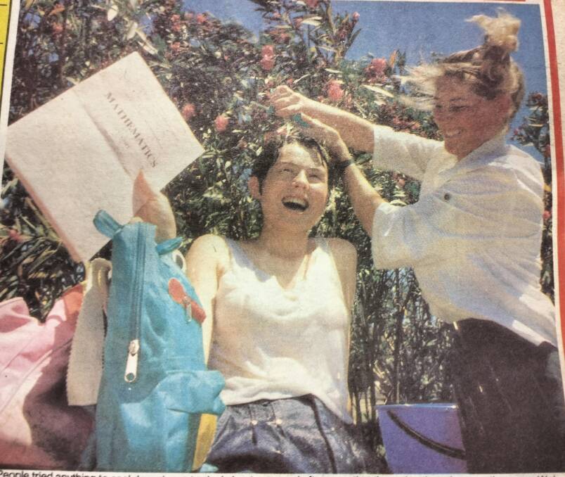 Wollongong High students Cara Warner and Nadine Caisley cool down after a very hot HSC exam.
