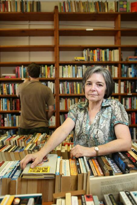 Perey's Books owner Dr Jo Abrantes packs up her stock in 2012 after having to close the doors. Picture by Adam McLean