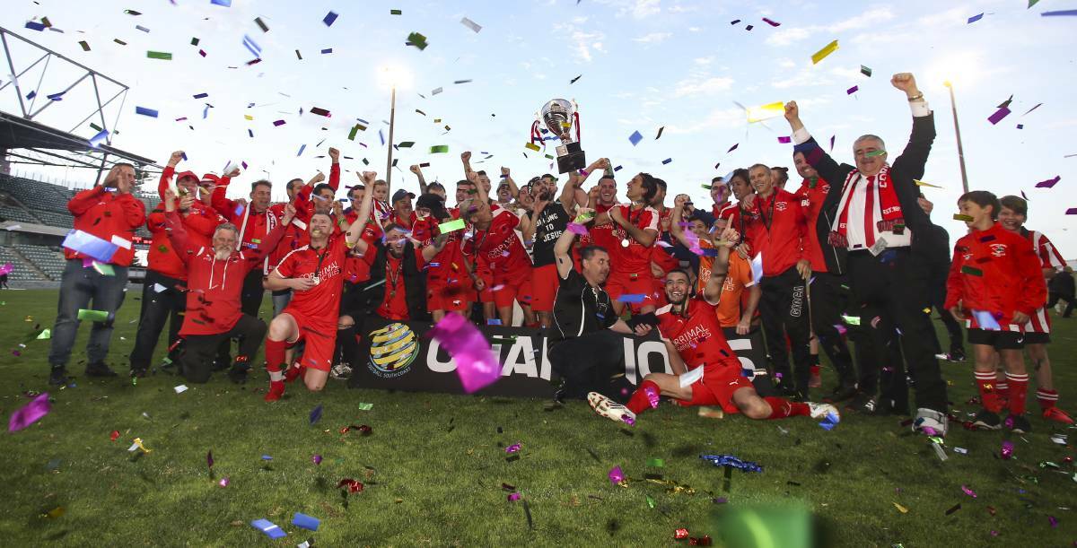 Rob Jonovski, his Corrimal players and support staff celebrate after winning the 2019 Premier League grand final. Picture by Anna Warr
