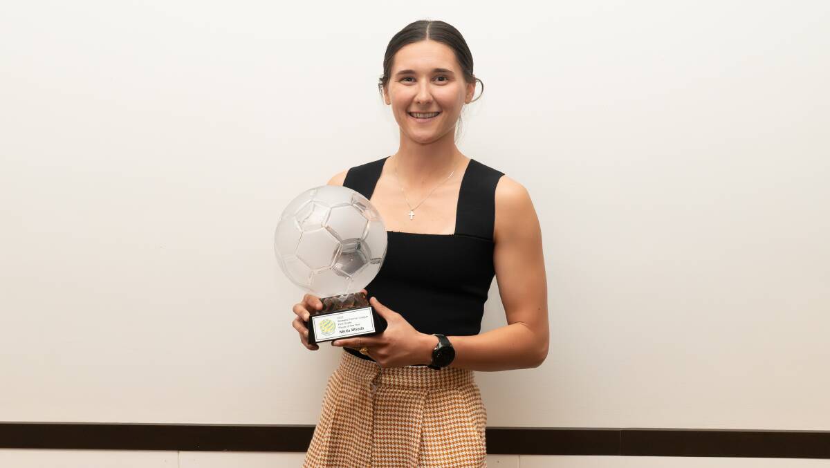 Woonona midfielder Nikita Woods holds up the spoils after being named the Women's Premier League's first-grade player of the year on Friday night. Picture - @gragrapix