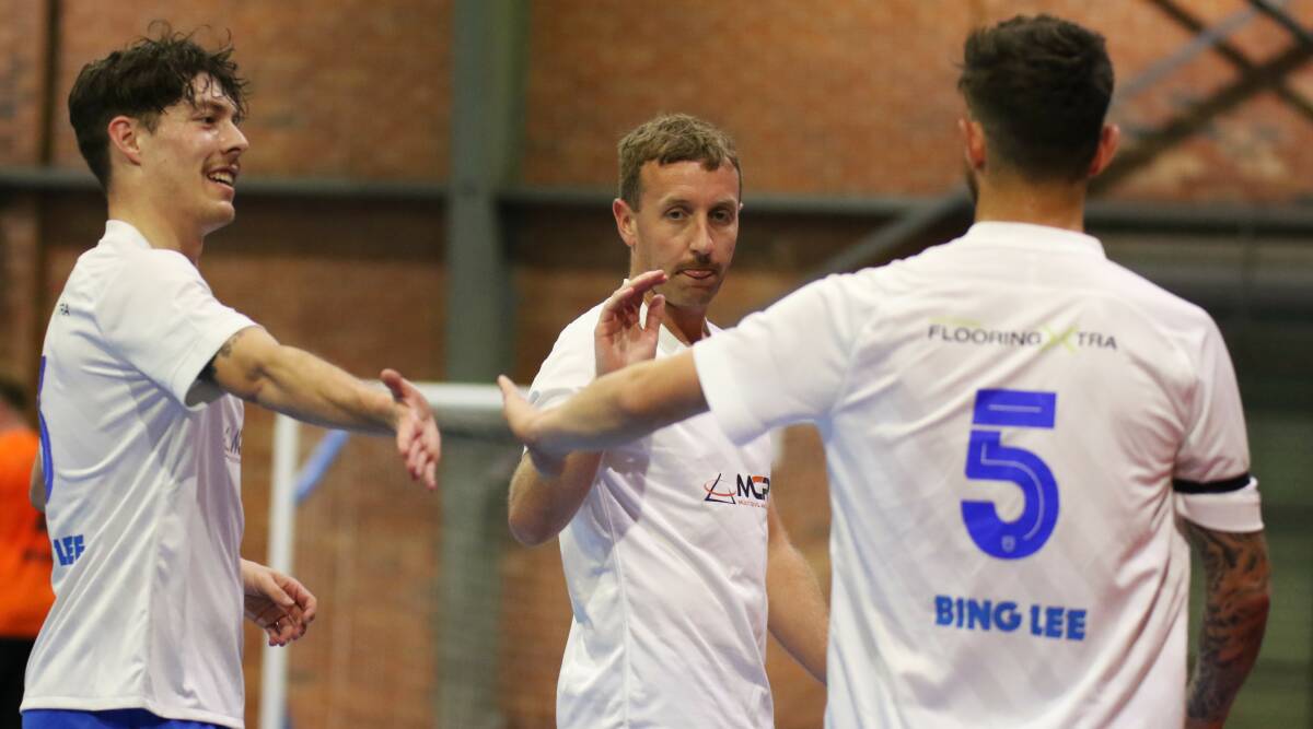 South Coast Taipans teammates (from left) Adam Voloder, Rick Goodchild and Matt Mazevski share a high-five after scoring a goal recently. Picture by Pedro Garcia 