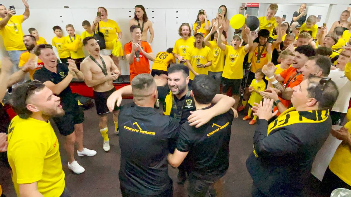 Coniston coaches, players and supporters celebrate after winning the 2023 Premier League grand final in the WIN Stadium changerooms. Picture by Adam McLean