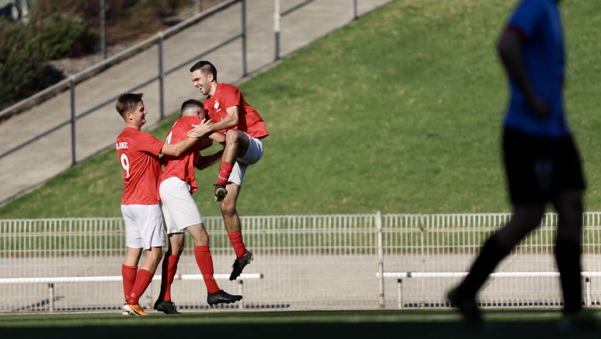 Mitch Turner (centre) celebrates with Fernhill teammates after scoring in Saturday's District League grand final at WIN Stadium. Picture by Adam McLean