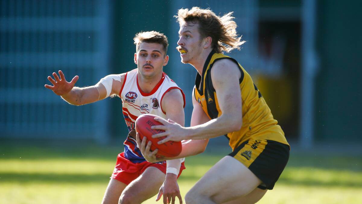 Heath Beaumont looks to handball to a Northern Districts teammate during a game in 2022. Picture by Anna Warr