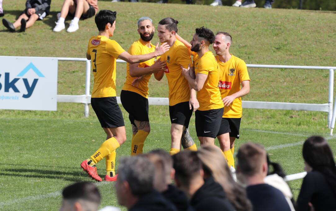 Toby Norval (centre) celebrates with his Coniston teammates after scoring a goal last season at JJ Kelly Park. Picture by Robert Peet