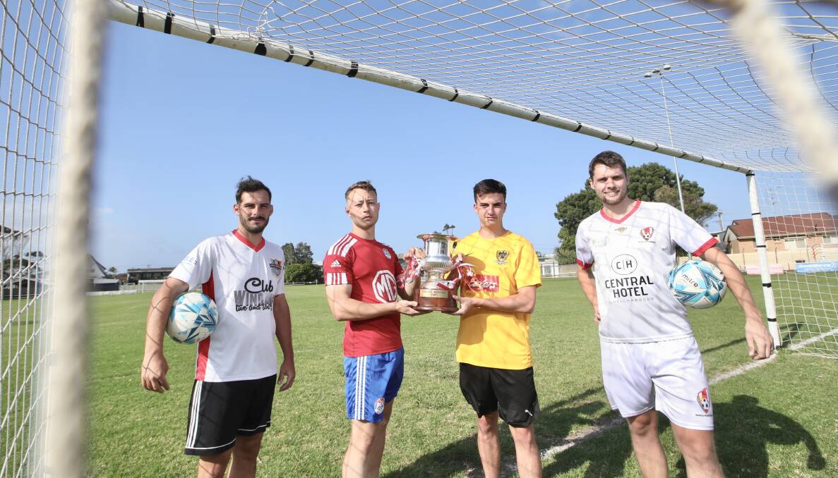 Footballers Corey Haines-Grose (Shellharbour), Riley Seadon (Albion Park), Tyson Black (Coniston) and Jack Murray (Warilla) with the Joe Moreno Cup. Picture by Sylvia Liber