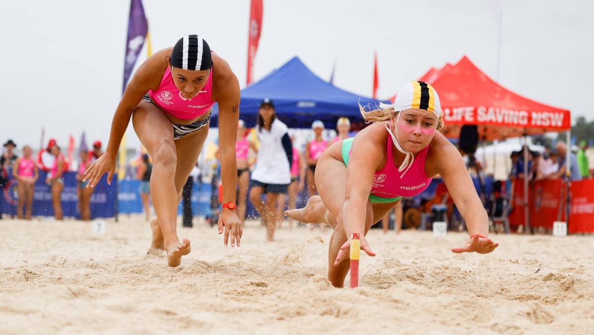 Mollymook junior Audrey Sakora and Port Macquarie's Ella Oliver battle in out in the under-14s female flags event last weekend at the NSW Country Surf Life Saving Championships. Picture by Anna Warr