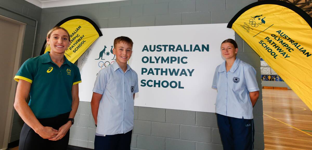 Wollongong Olympian Sarah Carli and Illawarra Sports High School students Loughlan Jackson and Callie Bright were thrilled to see the Berkeley school unveiled as an official Australian Olympic Pathway School on Thursday. Picture by Anna Warr