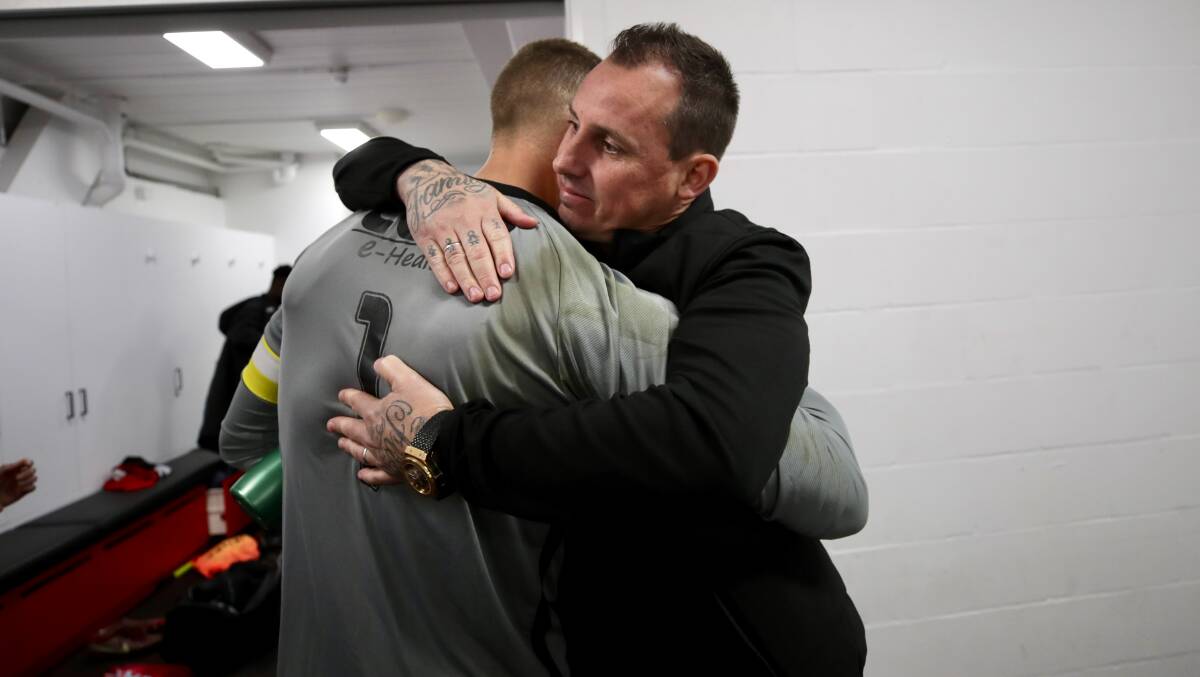 Luke Wilkshire hugs Wolves goalkeeper Hayden Durose after his last game in charge of the Wollongong NPL NSW outfit in July 2022. Picture by Adam McLean