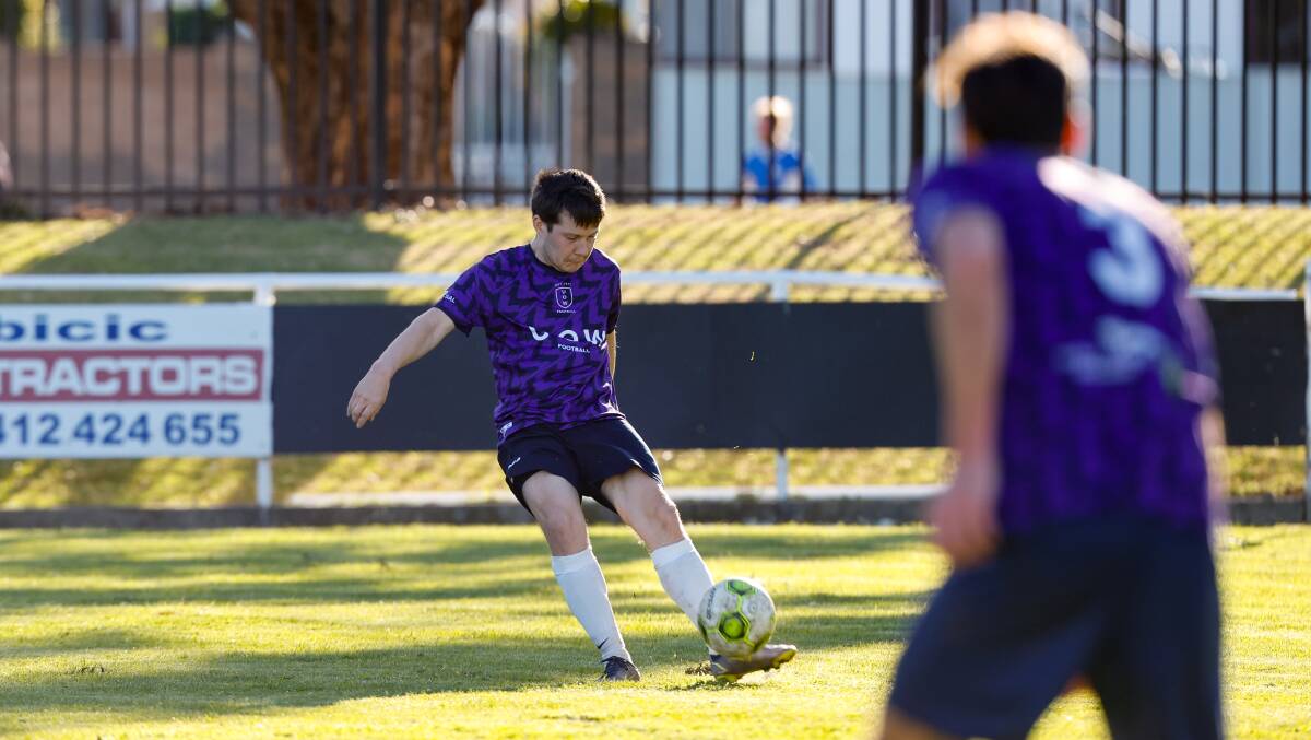 University of Wollongong's Christopher Twigg prepares to boot the ball down field during a District League match against Balgownie in August. Picture by Anna Warr