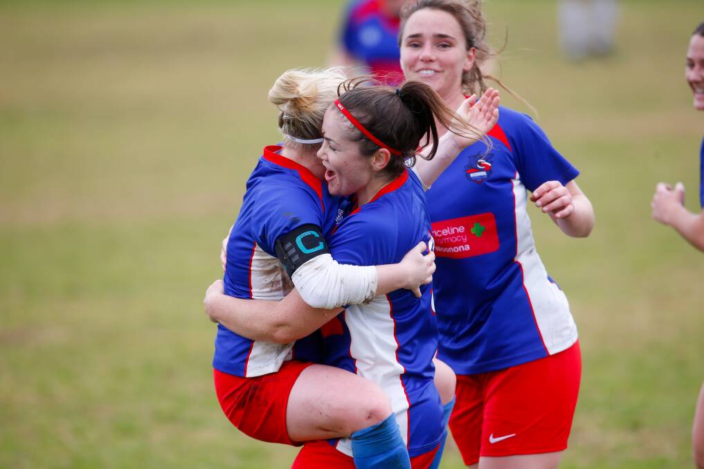 Ainsley Hawes celebrates with a Woonona teammate after scoring a goal for the Sharks last season. Picture by Anna Warr