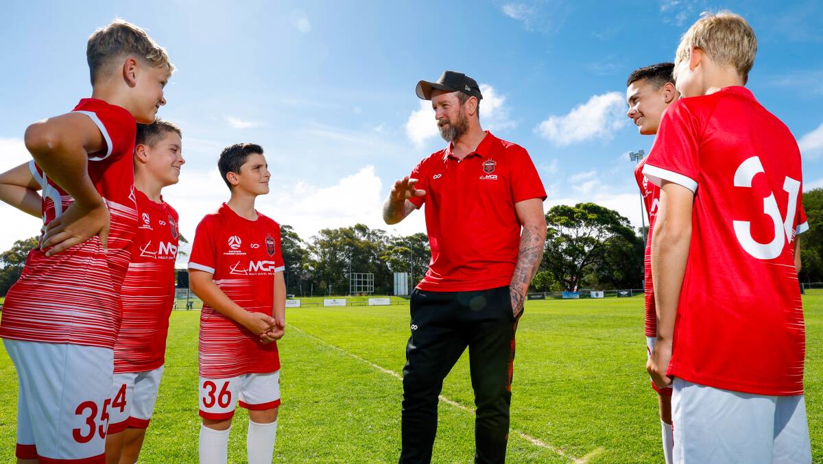 Wollongong Wolves head coach David Carney chats with the club's under-13s youth team players (from left) Luke Prouse, Logan Corbeski, Jett Ristevski, Chase Corbeski and Edward Page at Albert Butler Park on Tuesday afternoon. Picture by Anna Warr