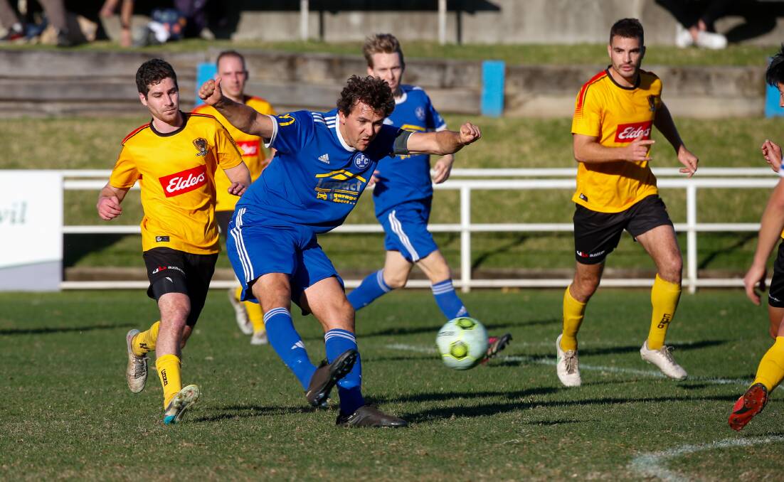Bulli striker Ben McDonald looms large for Corrimal's defensive unit at Memorial Park on Saturday. Picture by Anna Warr