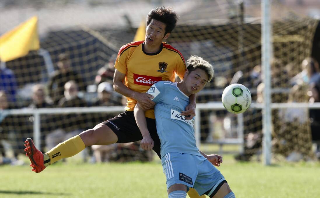 Coniston defender Takayuki Kayano (left) and Olympic's Yuto Sugiura battle for possession at JJ Kelly Park on Saturday. Picture by Adam McLean