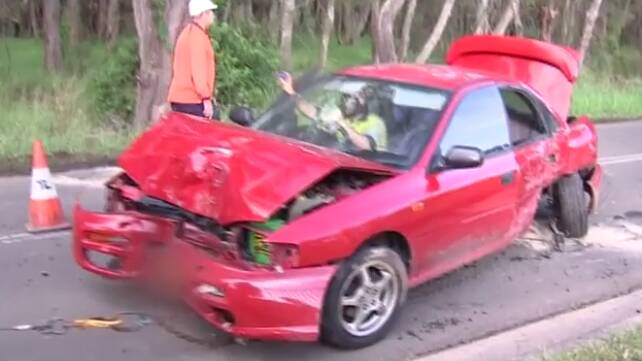 Wreckage: A red Subaru Impreza had to be towed away after the male driver crashed it into a tree and left the scene. Picture: WIN News Illawarra