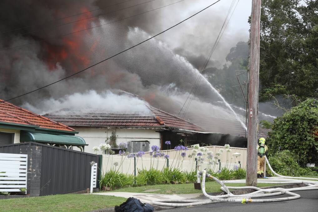 Firefighters battle the West Wollongong blaze. Picture by Robert Peet