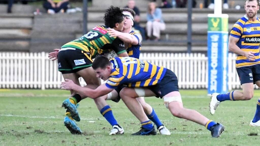 Eamon Doyle, in Sydney university colours, puts his back in stopping an acttacking raid. Picture supplied