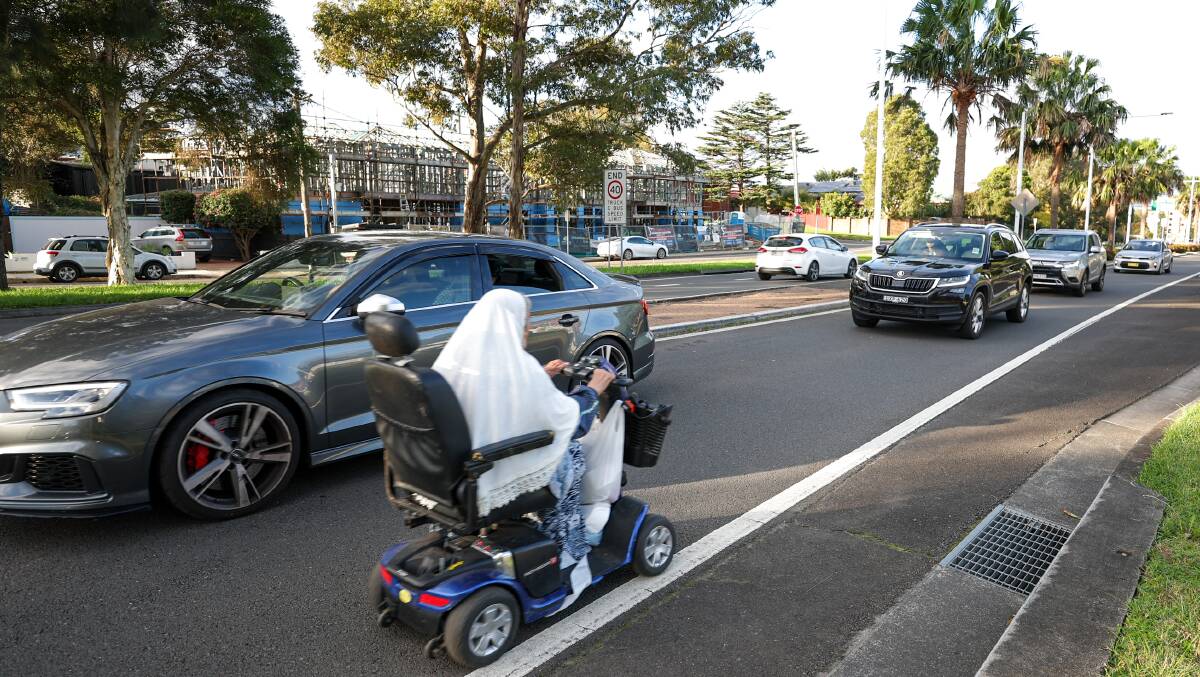 A person on a mobility scooter navigates Mount Ousley Road. Picture by Adam McLean 