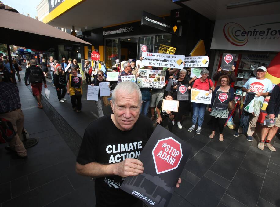 'Don't bank on Adani mine': Tom Hunt fronts the group of protesters in Crown Street Mall. Picture: Robert Peet.