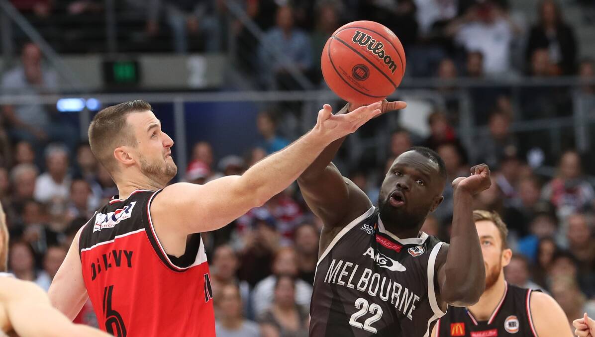 TIGHT TUSSLE: Big men AJ Ogilvy and Majok Majok battle for the ball in Melbourne's 78-72 win over the Hawks on Monday. Picture: Getty Images