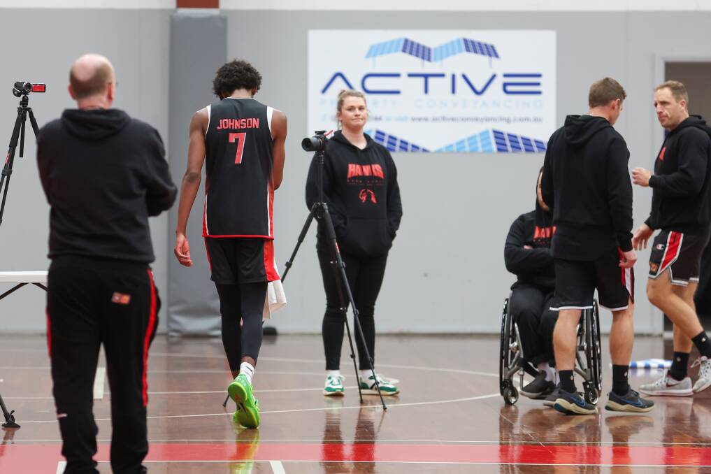 AJ Johnson leaves Hawks practice to get his injured nose treated. Picture by Adam McLean