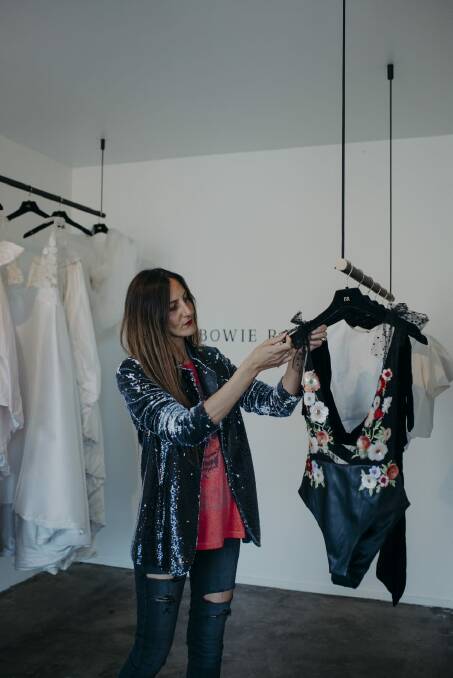 Manal Waugh adjusts a bodysuit hanging at her newly opened Woonona studio. Picture supplied by Sea-People Photography