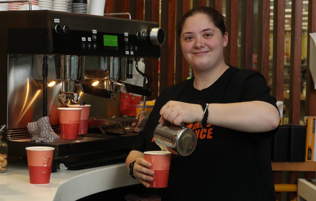 Supported employee Bianca Goldman making coffee at the newly opened Brewing Up A Storm in Wollongong Library. Picture by Robert Peet