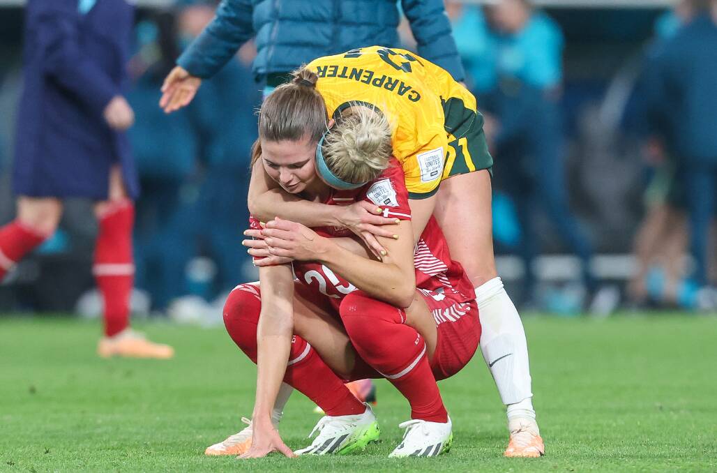 Matildas player Ellie Carpenter consoles a player from Denmark in the Women's World Cup 2023. Picture by Adam McLean