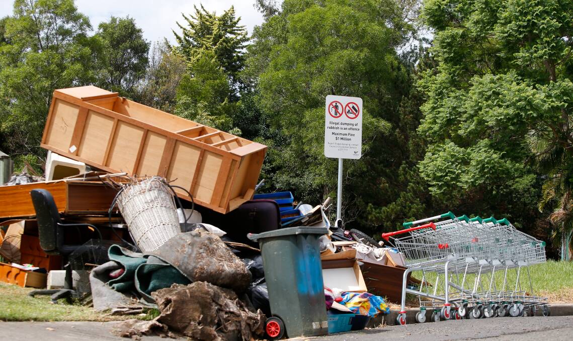 DUMPSITE DISGRACE: Residents are disgusted by the blatant illegal dumping on Helen Brae Ave at Fairy Meadow. The sign in shot warns of big fines for dumping. Picture: Adam McLean.