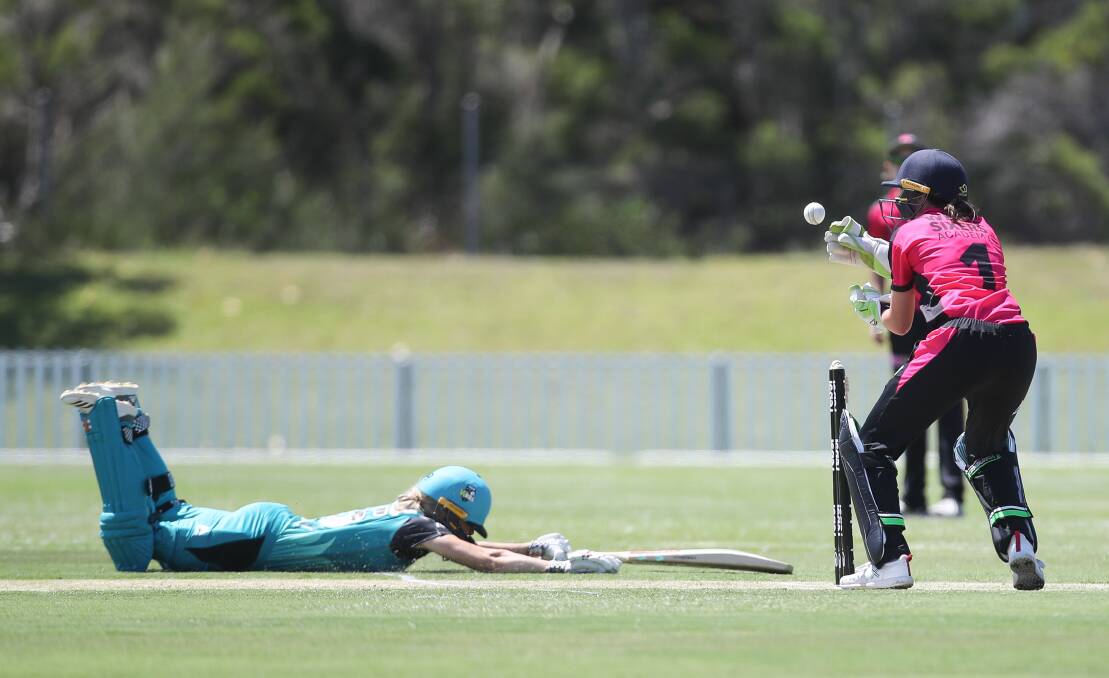 Close call: Heat's Jemma Barsby makes it into the crease before Albion Park's Tahlia Wilson can take the bails off on Tuesday. Picture: Adam McLean