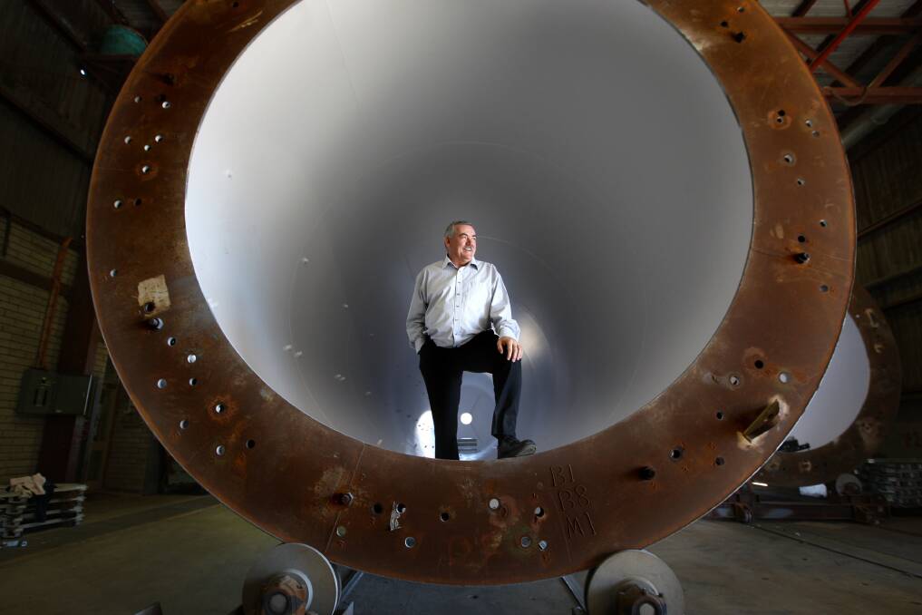 Steve Garner inside a wind tower component at the Keppel Prince factory in Portland, Victoria. Picture by Angela Milne.