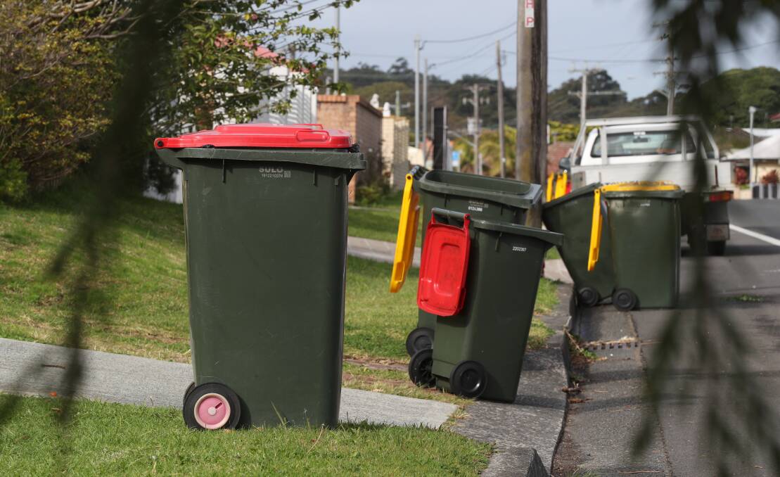 Red-lid bins in Wollongong. The city council could not say how many people mentioned fortnightly collection during consultation. Picture by Robert Peet
