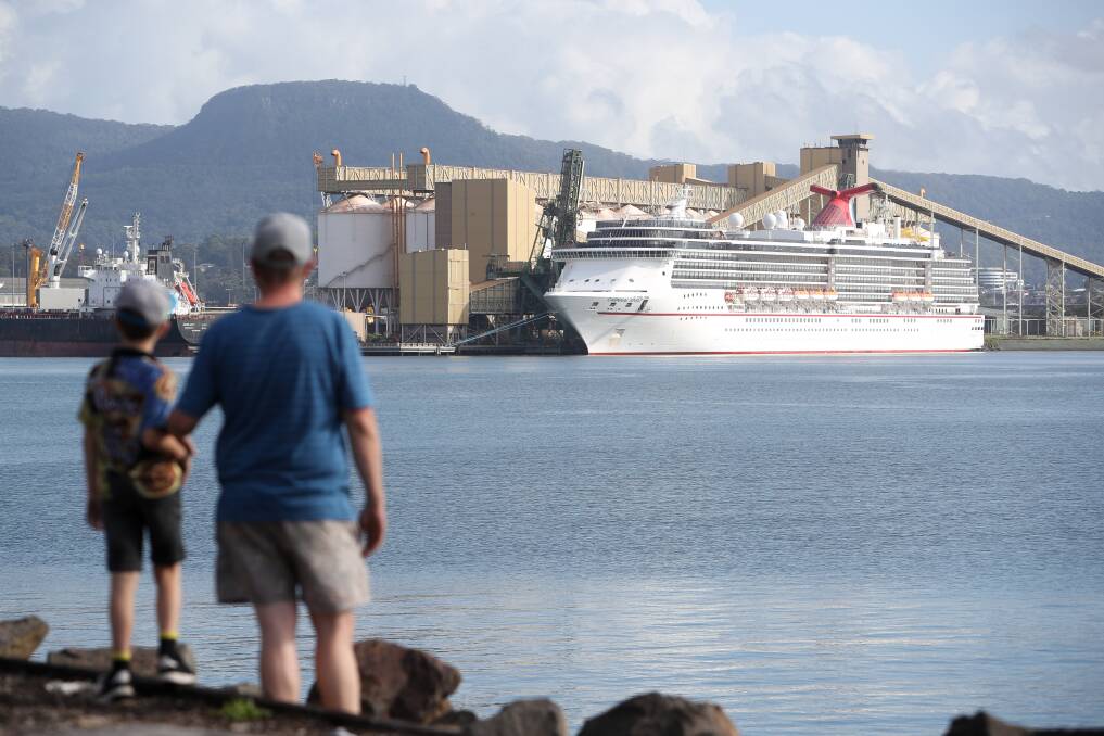 Rowan Bailey and son Cooper watch the Carnival Spirit as it stopped in Port Kembla in March 2020. Picture by Adam McLean.